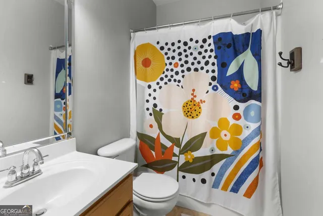 a bedroom with a bed and a flat tv screen on the dresser