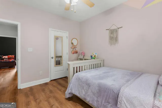 a view of roof deck with table and chairs and wooden floor
