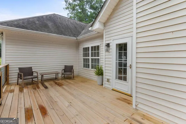 a view of a porch with a bench and potted plant