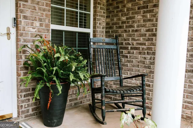 a front view of a house with garden and porch