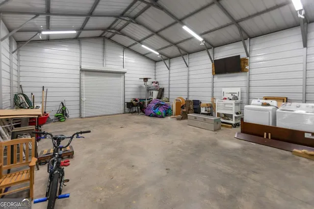 an aerial view of residential houses with outdoor space and trees
