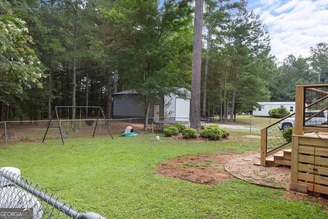 a view of a backyard with a garden and entertaining space