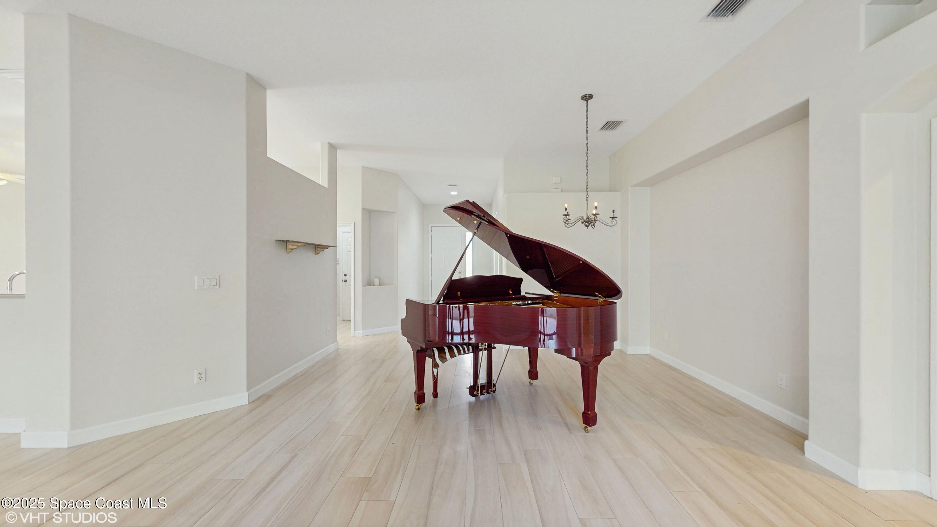 652 Hatteras Court Southwest Vero Beach, FL 32968 - Photo 11 of 48 a sitting area with furniture and wooden floor