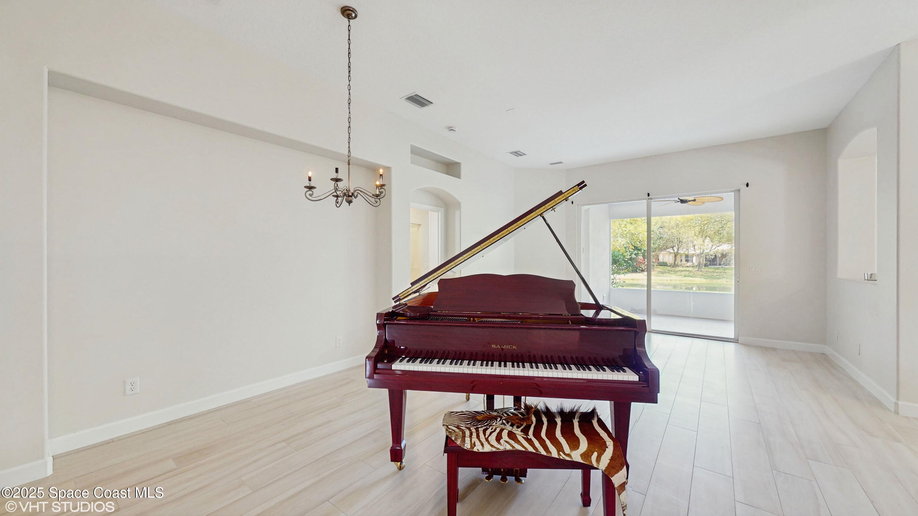 652 Hatteras Court Southwest Vero Beach, FL 32968 - Photo 13 of 48 a view of a hallway with wooden floor and stairs
