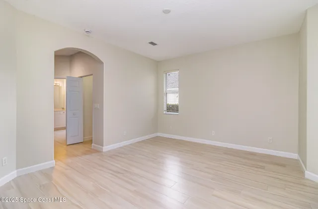 an empty room with wooden floor and closet