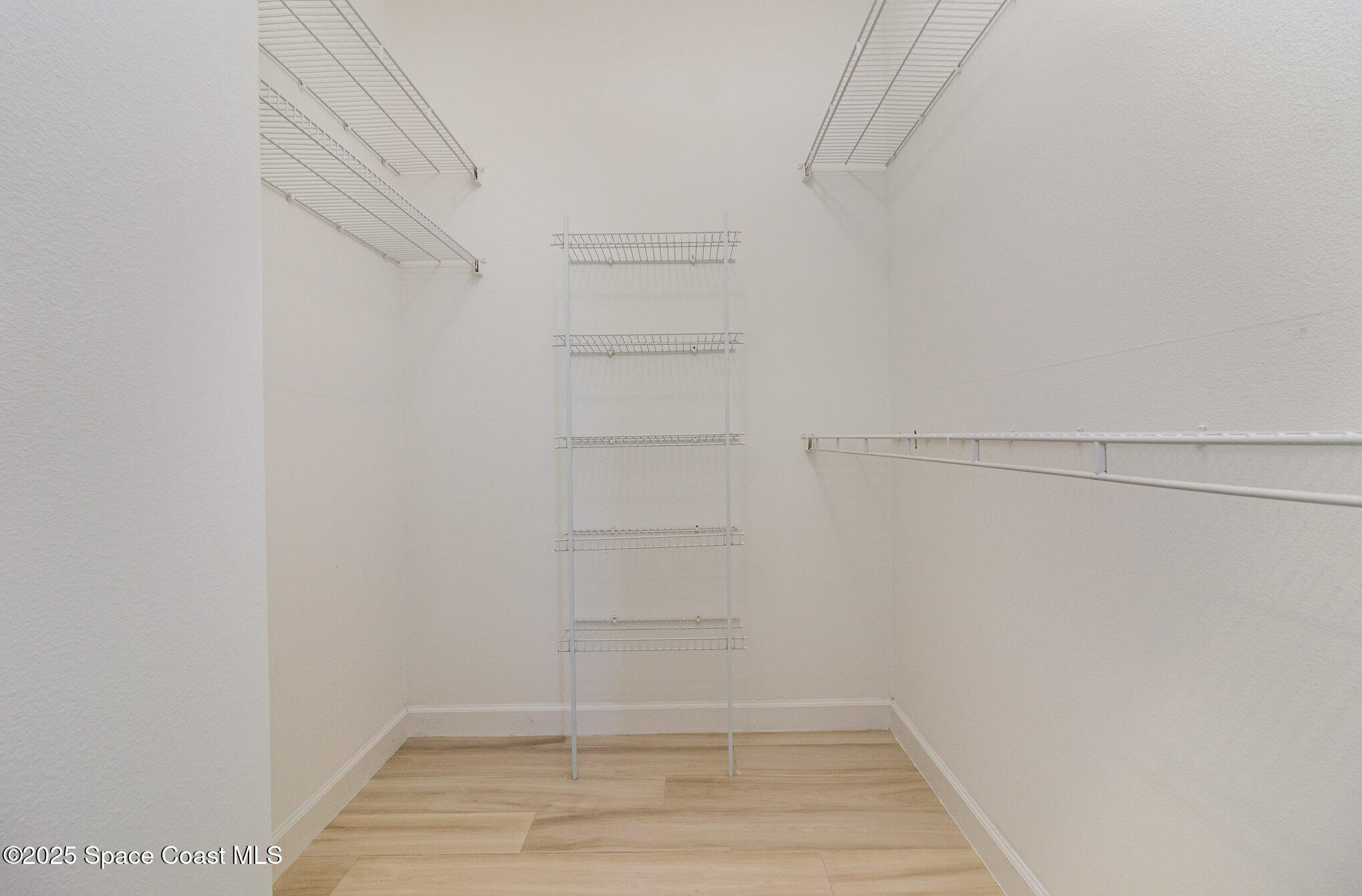 652 Hatteras Court Southwest Vero Beach, FL 32968 - Photo 18 of 48 a view of an empty walk in closet