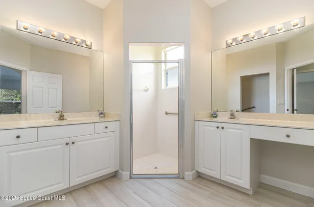 a bathroom with a double vanity sink and mirror