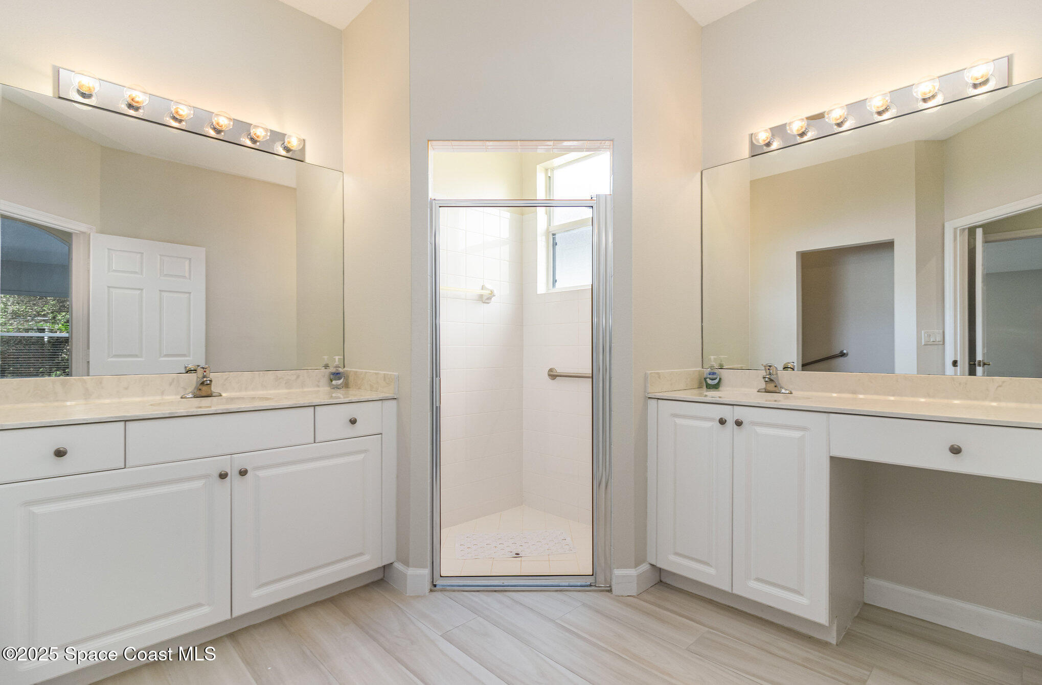 652 Hatteras Court Southwest Vero Beach, FL 32968 - Photo 20 of 48 a bathroom with a double vanity sink and mirror