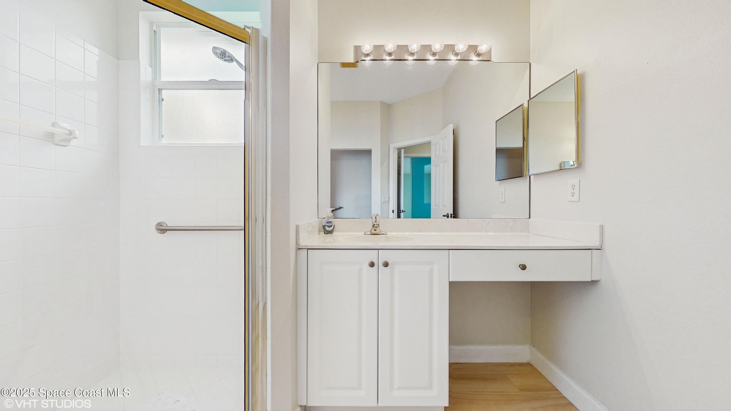 652 Hatteras Court Southwest Vero Beach, FL 32968 - Photo 21 of 48 a bathroom with a sink and a mirror