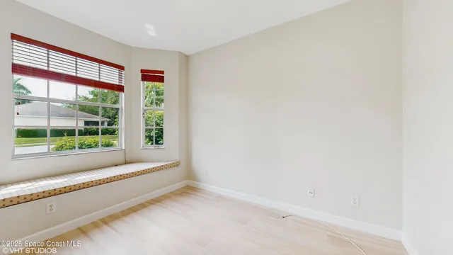 a view of room with window and front door