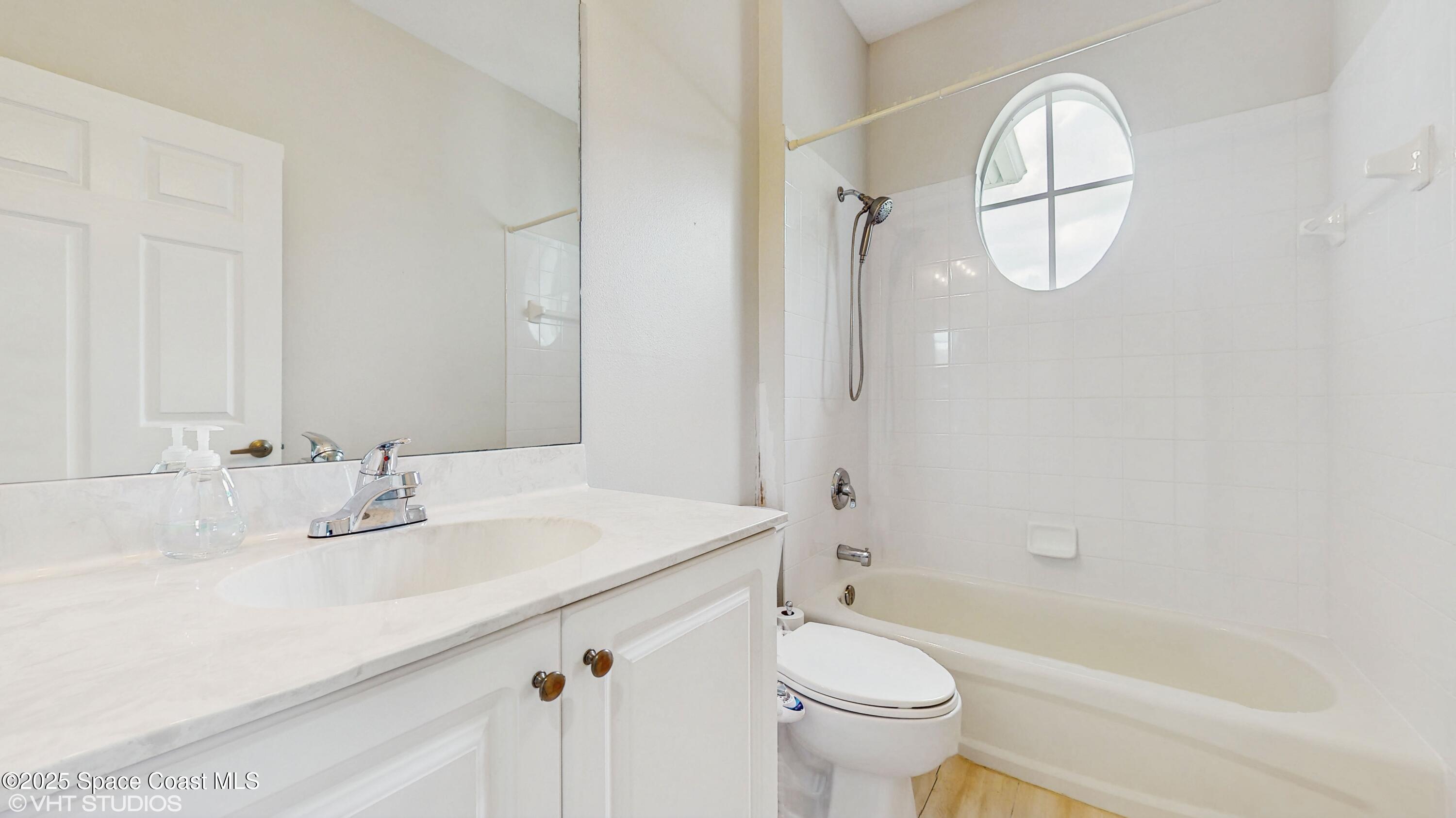 652 Hatteras Court Southwest Vero Beach, FL 32968 - Photo 24 of 48 a bathroom with a sink a toilet and a mirror