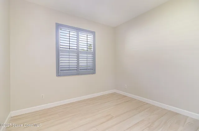wooden floor in an empty room with a window