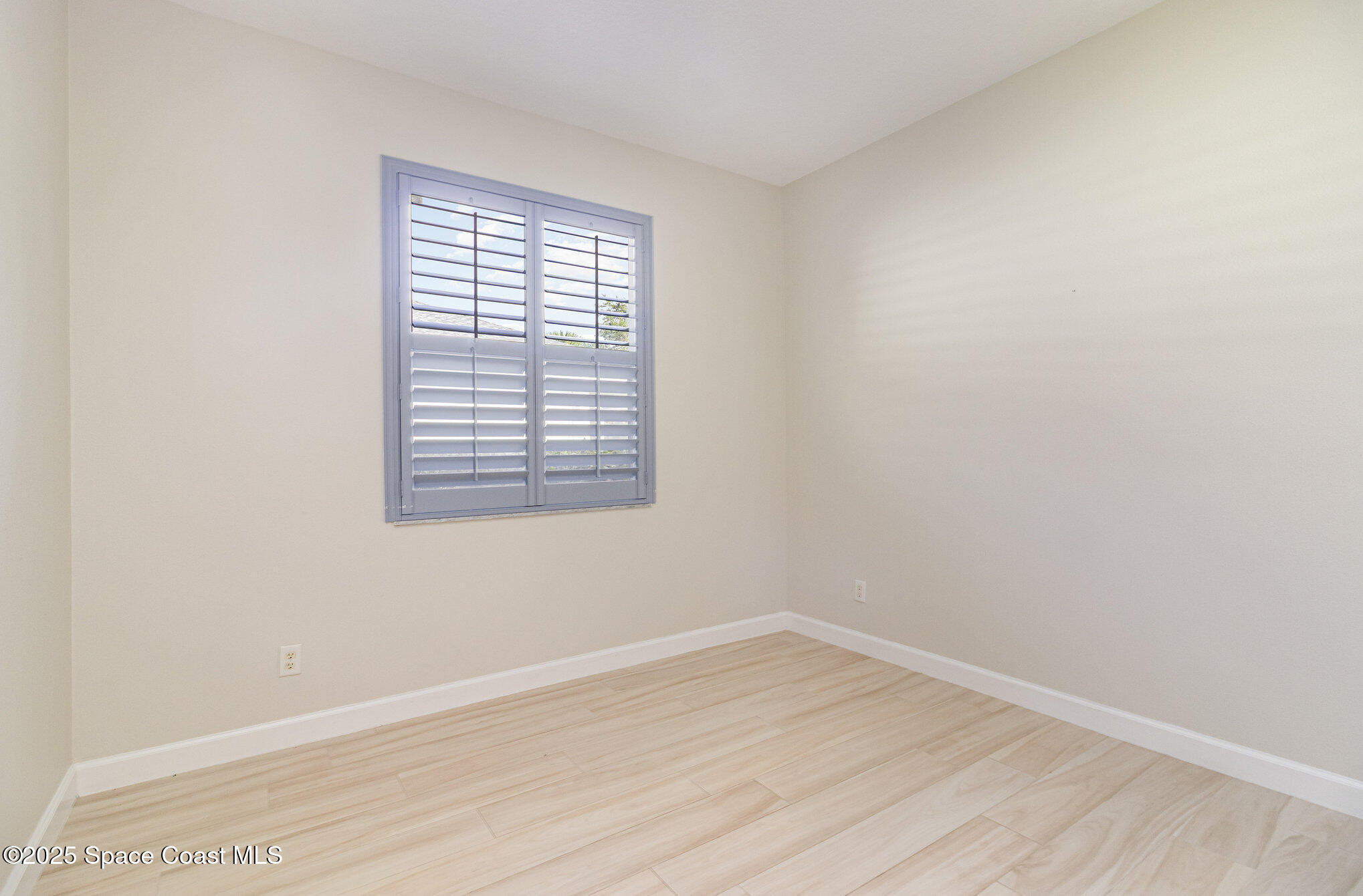 652 Hatteras Court Southwest Vero Beach, FL 32968 - Photo 25 of 48 wooden floor in an empty room with a window