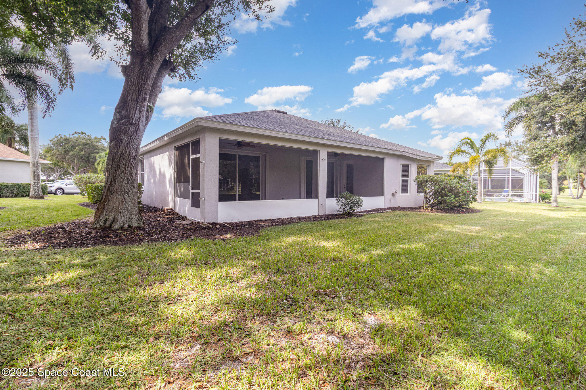 652 Hatteras Court Southwest Vero Beach, FL 32968 - Photo 34 of 48 a view of a house with a big yard and large tree