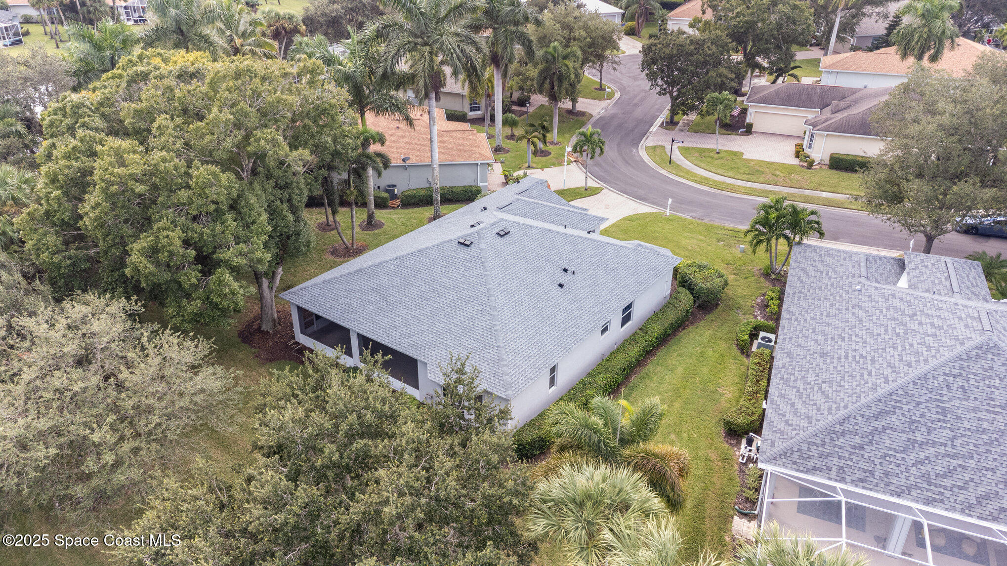 652 Hatteras Court Southwest Vero Beach, FL 32968 - Photo 37 of 48 an aerial view of a house with swimming pool and large trees