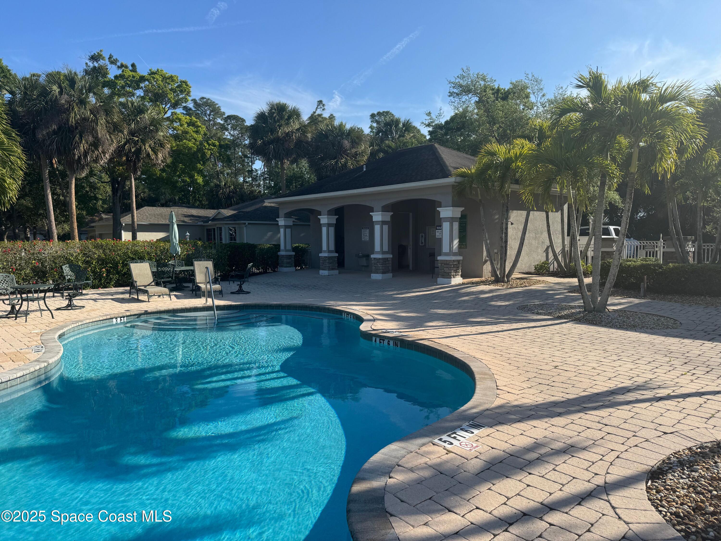 652 Hatteras Court Southwest Vero Beach, FL 32968 - Photo 40 of 48 a view of a swimming pool with a patio