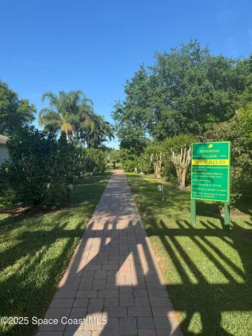 a view of a house with a yard from a lake view