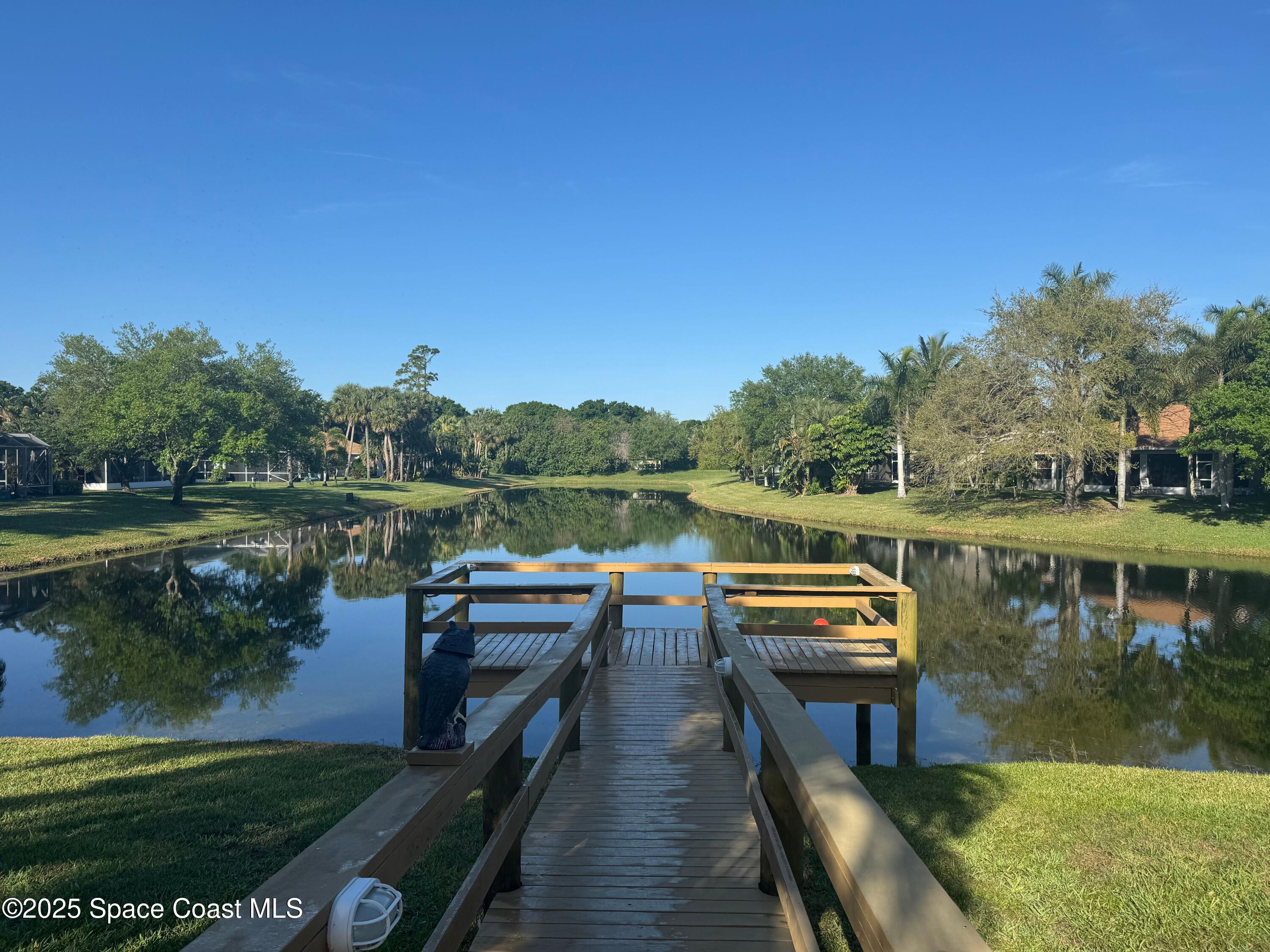 652 Hatteras Court Southwest Vero Beach, FL 32968 - Photo 45 of 48 a view of a lake with wooden deck and outdoor space