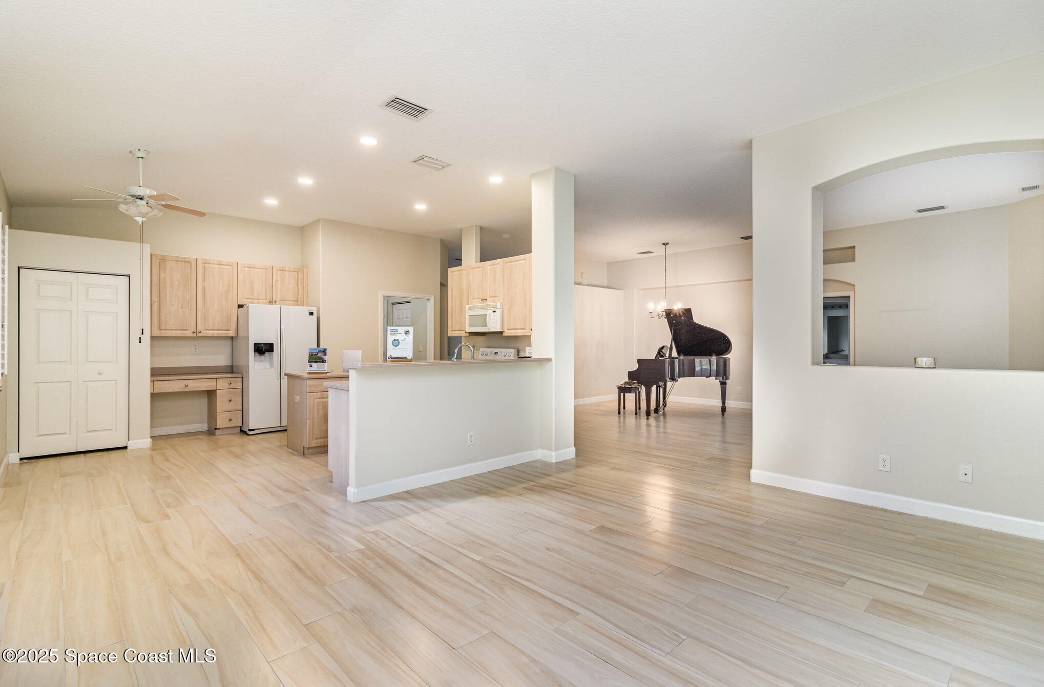 652 Hatteras Court Southwest Vero Beach, FL 32968 - Photo 8 of 48 a view of kitchen dining table chairs microwave and cabinets