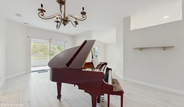 a view of a room with furniture wooden floor and windows