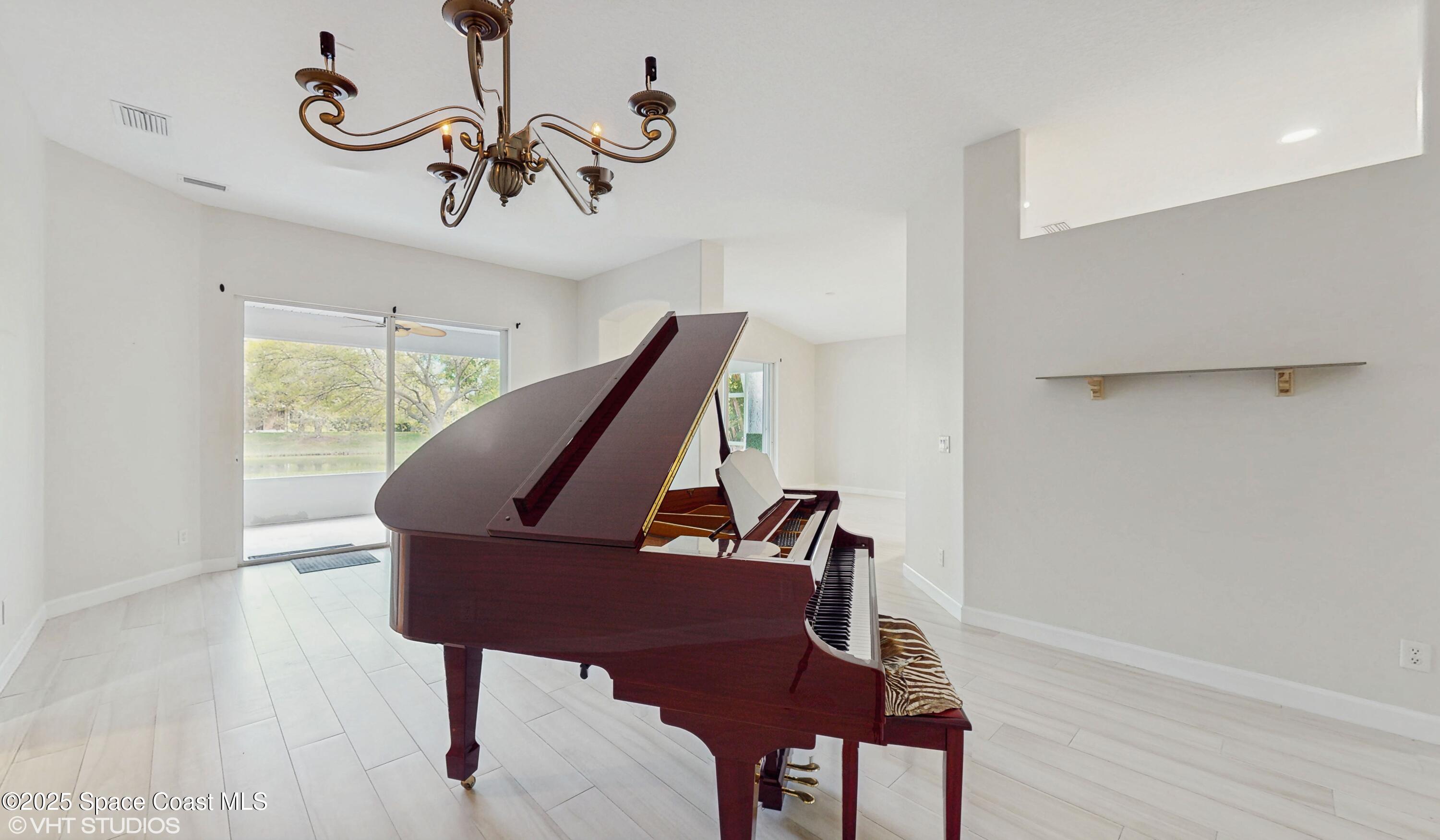 652 Hatteras Court Southwest Vero Beach, FL 32968 - Photo 10 of 48 a view of a room with furniture wooden floor and windows