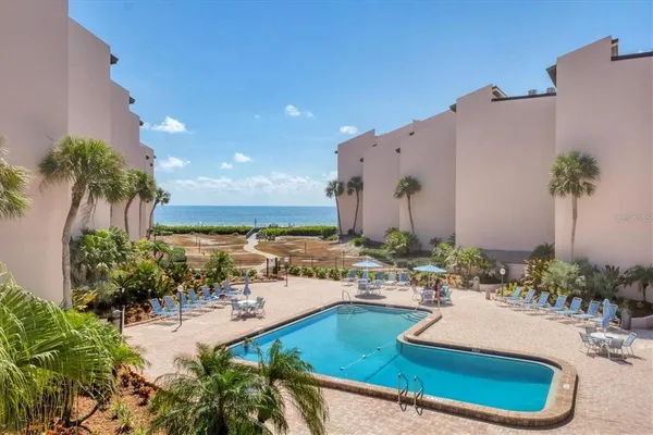 a swimming pool with outdoor seating and yard