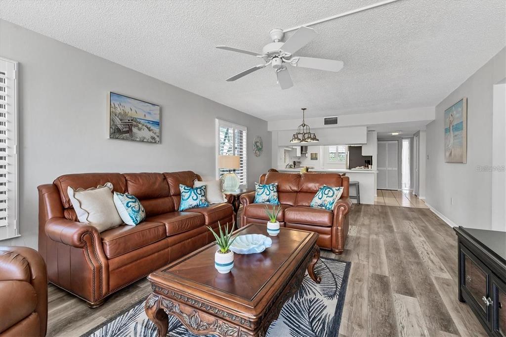 6480 Midnight Pass Road, Unit 311 Sarasota, FL 34242 - Photo 13 of 48 a living room with furniture kitchen view and a chandelier