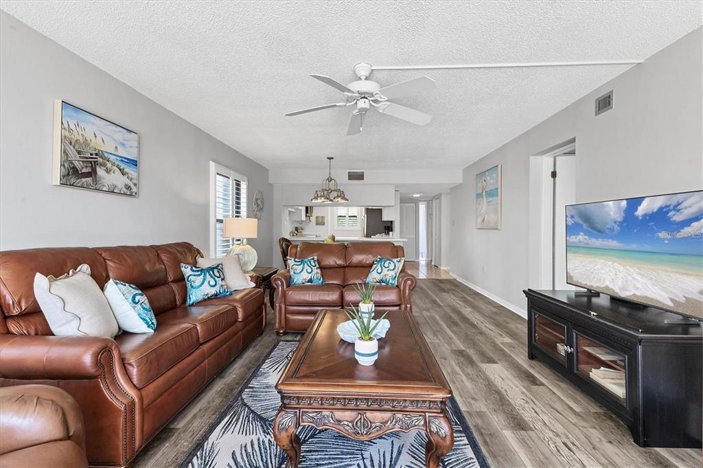 6480 Midnight Pass Road, Unit 311 Sarasota, FL 34242 - Photo 14 of 48 a living room with furniture and a flat screen tv