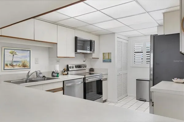 a kitchen with a sink cabinets and stainless steel appliances