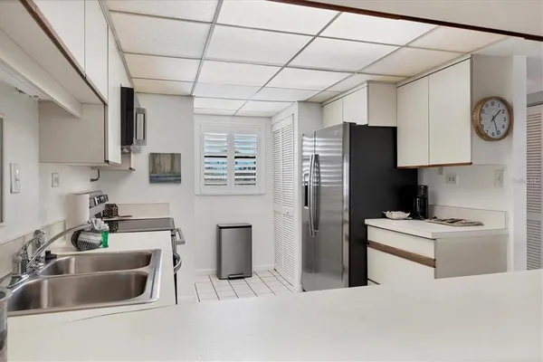 a kitchen with stainless steel appliances a refrigerator sink and microwave