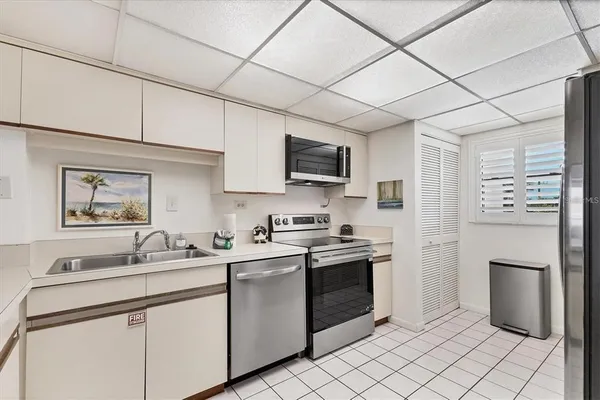 a kitchen with a sink cabinets and stainless steel appliances