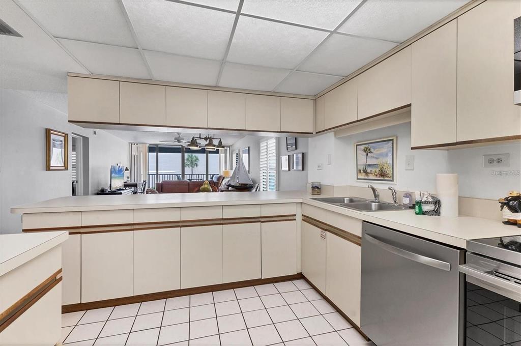 6480 Midnight Pass Road, Unit 311 Sarasota, FL 34242 - Photo 19 of 48 a kitchen with a sink and cabinets