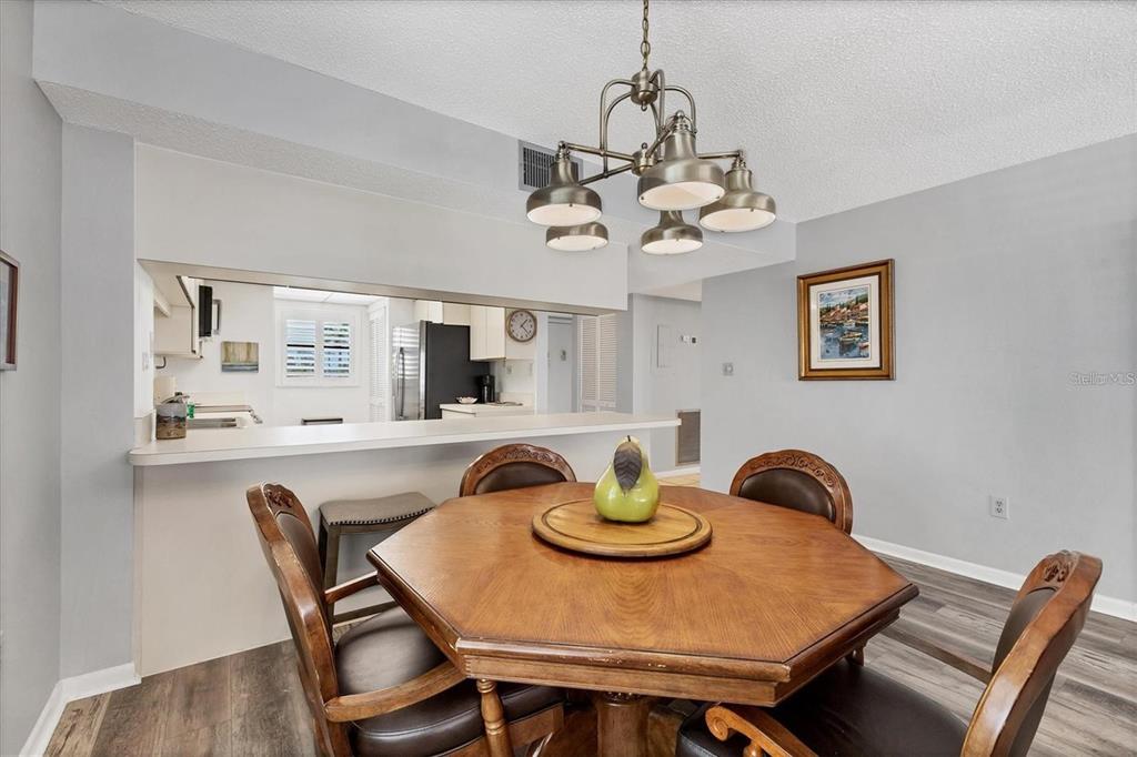 6480 Midnight Pass Road, Unit 311 Sarasota, FL 34242 - Photo 23 of 48 a view of a dining room with furniture and chandelier