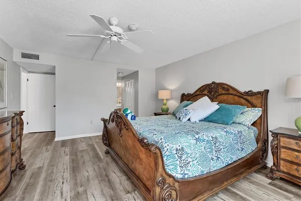 a bedroom with a bed and a ceiling fan