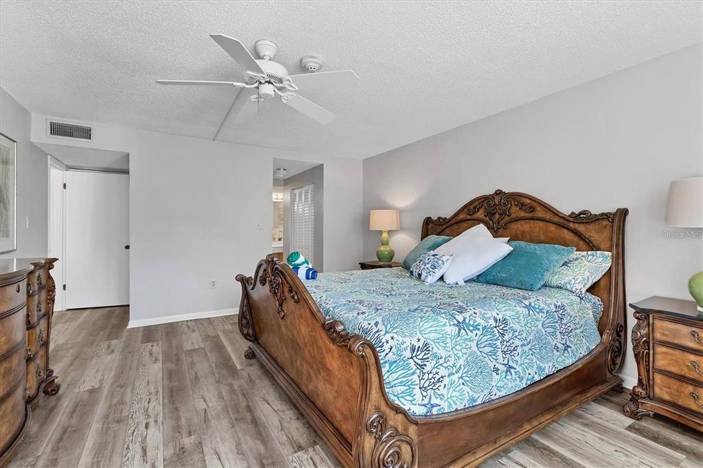 6480 Midnight Pass Road, Unit 311 Sarasota, FL 34242 - Photo 25 of 48 a bedroom with a bed and a ceiling fan