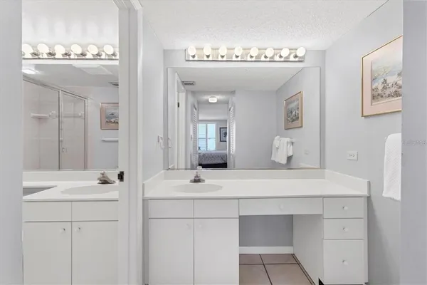 a bathroom with a double vanity sink mirror and