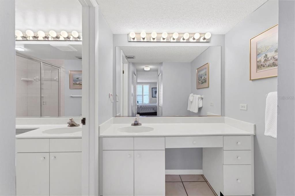 6480 Midnight Pass Road, Unit 311 Sarasota, FL 34242 - Photo 26 of 48 a bathroom with a double vanity sink mirror and