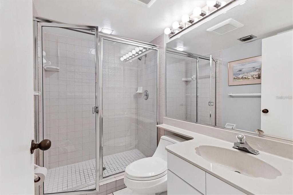 6480 Midnight Pass Road, Unit 311 Sarasota, FL 34242 - Photo 27 of 48 a bathroom with a sink a toilet and shower