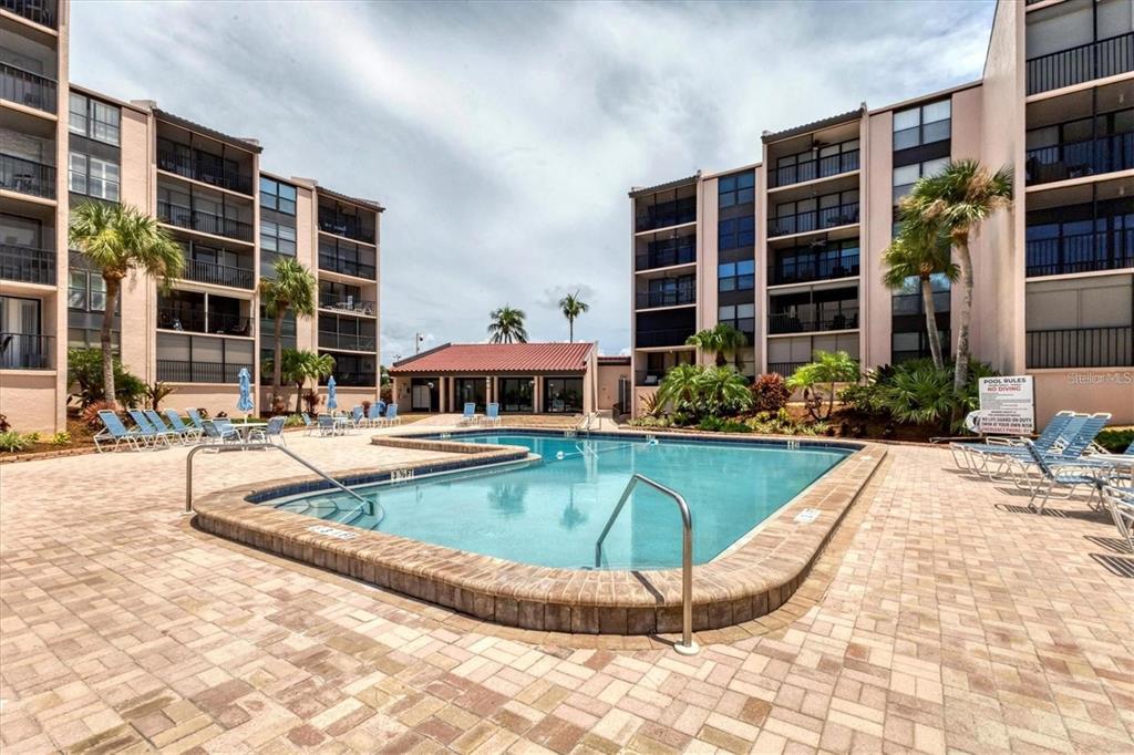 6480 Midnight Pass Road, Unit 311 Sarasota, FL 34242 - Photo 37 of 48 a view of a swimming pool with a lounge chairs
