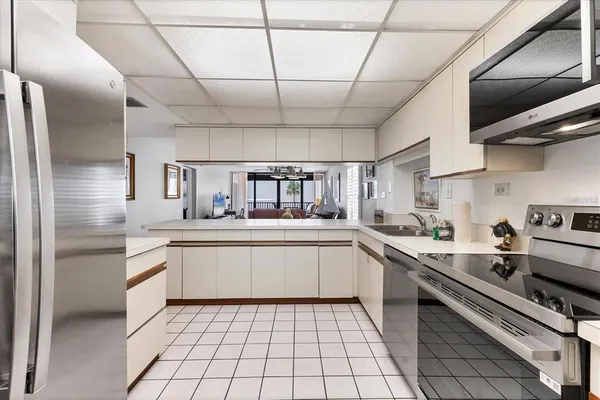 a kitchen with stainless steel appliances a sink stove and cabinets