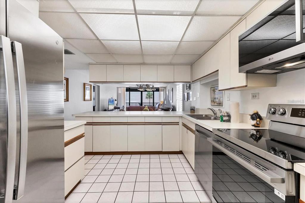6480 Midnight Pass Road, Unit 311 Sarasota, FL 34242 - Photo 6 of 48 a kitchen with stainless steel appliances a sink stove and cabinets