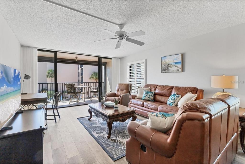 6480 Midnight Pass Road, Unit 311 Sarasota, FL 34242 - Photo 9 of 48 a living room with furniture and a large window