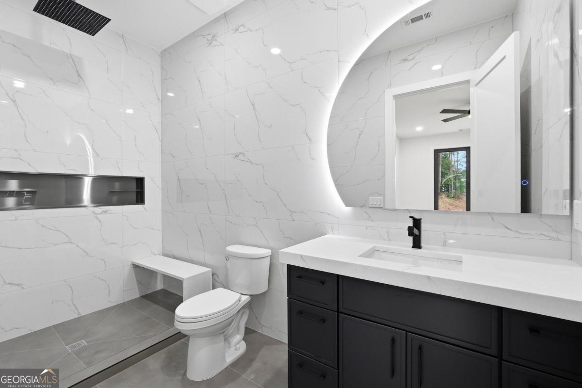 1563 Whitley Road Bethlehem, GA 30620 - Photo 33 of 44 a bathroom with a sink a toilet a mirror and shower