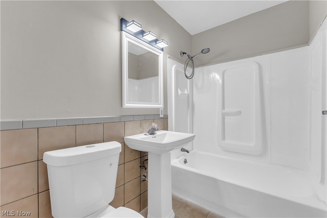 18517 Homeway Road Cleveland, OH 44135 - Photo 19 of 29 Bathroom featuring a pedestal sink, white toilet, and tub/shower combination