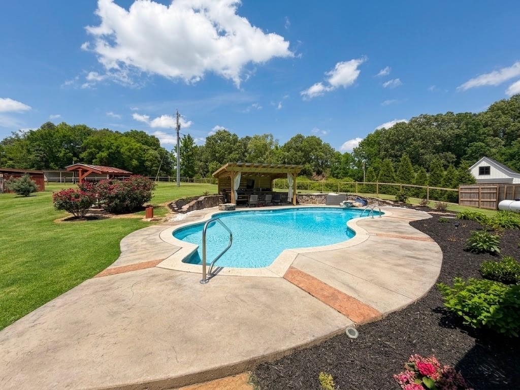 897 Burrowtown Road Mason, TN 38049 - Photo 37 of 40 a swimming pool with outdoor seating and garden
