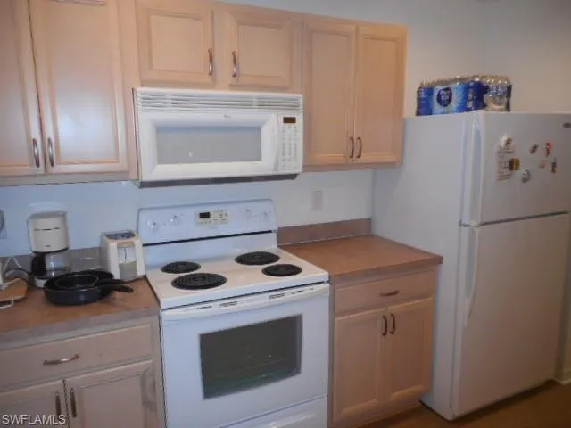 a kitchen with a stove and a refrigerator