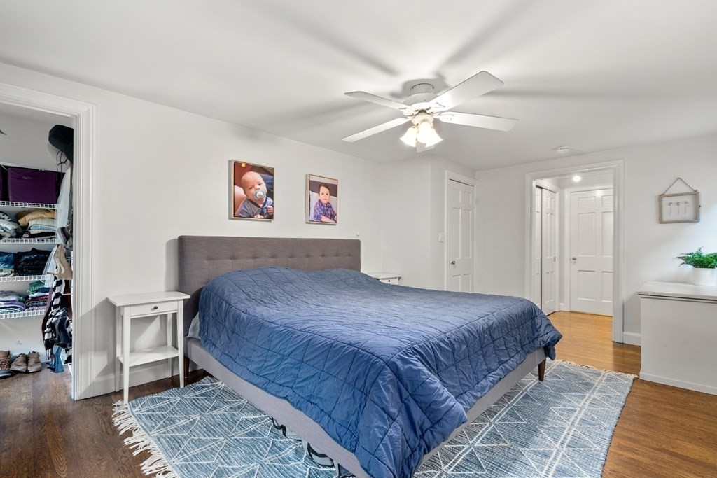 29 Martin Road Wellesley, MA 02481 - Photo 19 of 29 a spacious bedroom with a bed and a chandelier