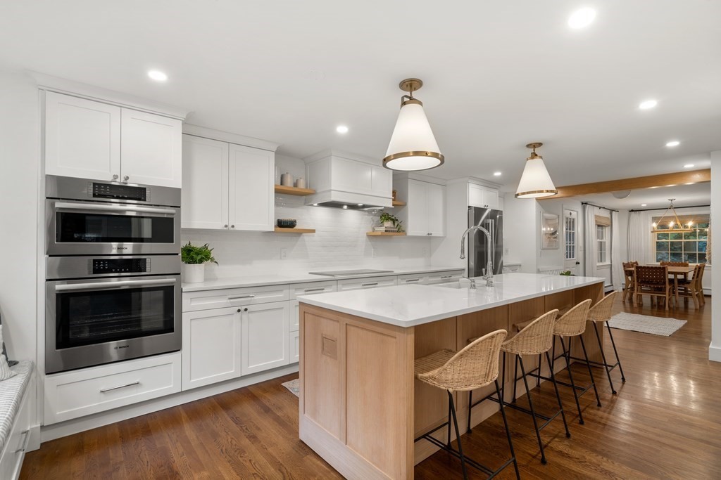 29 Martin Road Wellesley, MA 02481 - Photo 3 of 29 a kitchen with stainless steel appliances a kitchen island hardwood floor sink stove dining table and chairs