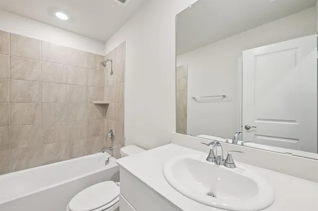a bathroom with a sink toilet and bathtub