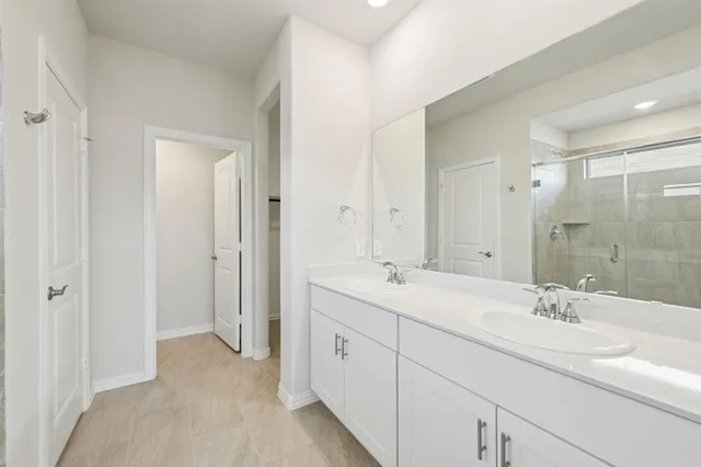a bathroom with a double vanity sink mirror and